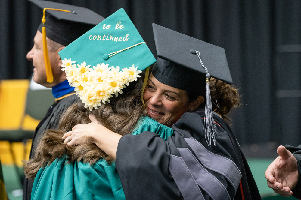 Graduate hugs professor