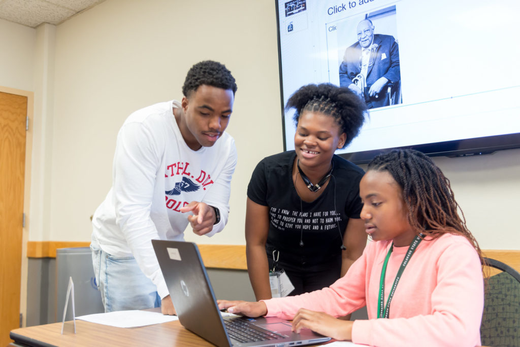 High school students work on computer at Black Issues Forum