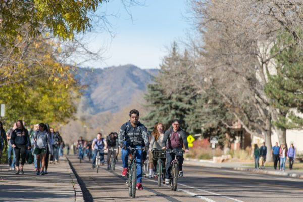 Colorado State University students ride bicycles on the bike path on Plum Street, November 4, 2015.