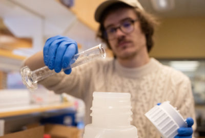 Jackson Watkins, a graduate student in Microbiology Immunology and Pathology uses lab alcohol, glycol and hydrogen peroxide to make hand sanitizer for campus use. March 23, 2020