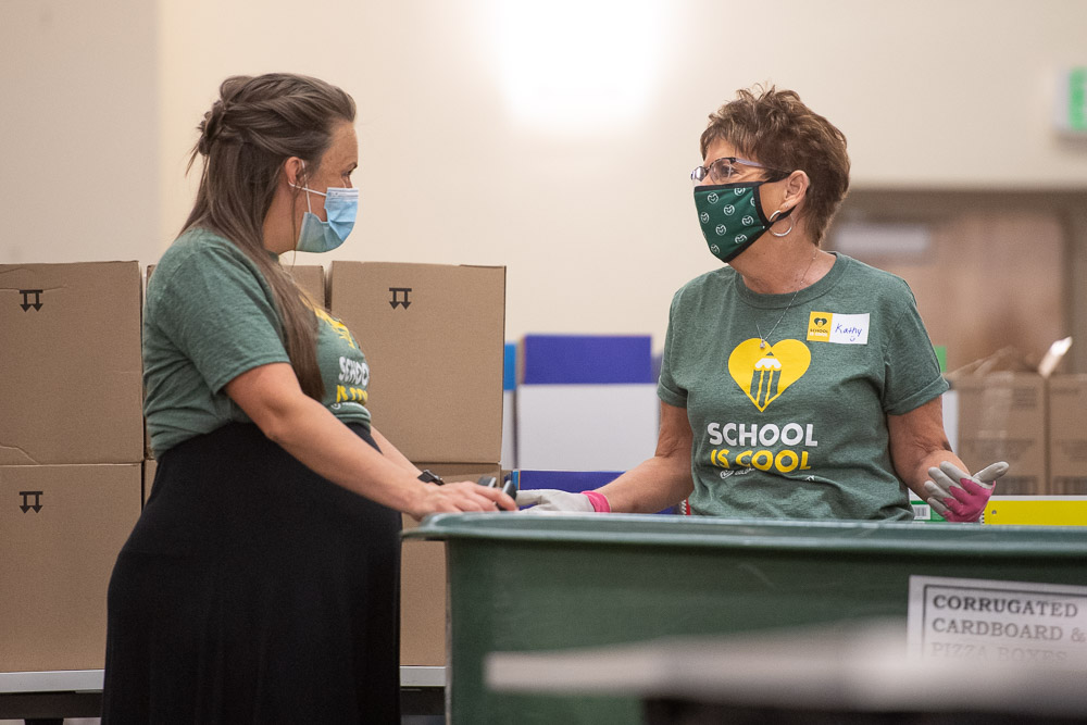 Volunteers stuff school supplies in to backpacks for School is Cool. 2800 backpacks will be distributed to Poudre School District students and 300 backpacks will be distributed to CSU students. August 5, 2020