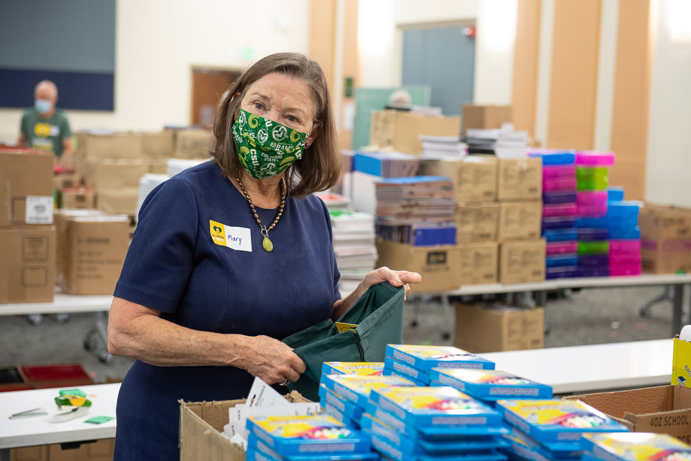 Mary Pederson, Provost of Colorado State University, helps stuff school supplies in to backpacks for School is Cool. 2800 backpacks will be distributed to Poudre School District students and 300 backpacks will be distributed to CSU students. August 5, 2020