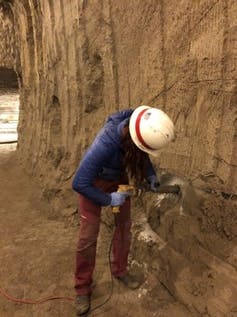 The author using a drill in tunnel