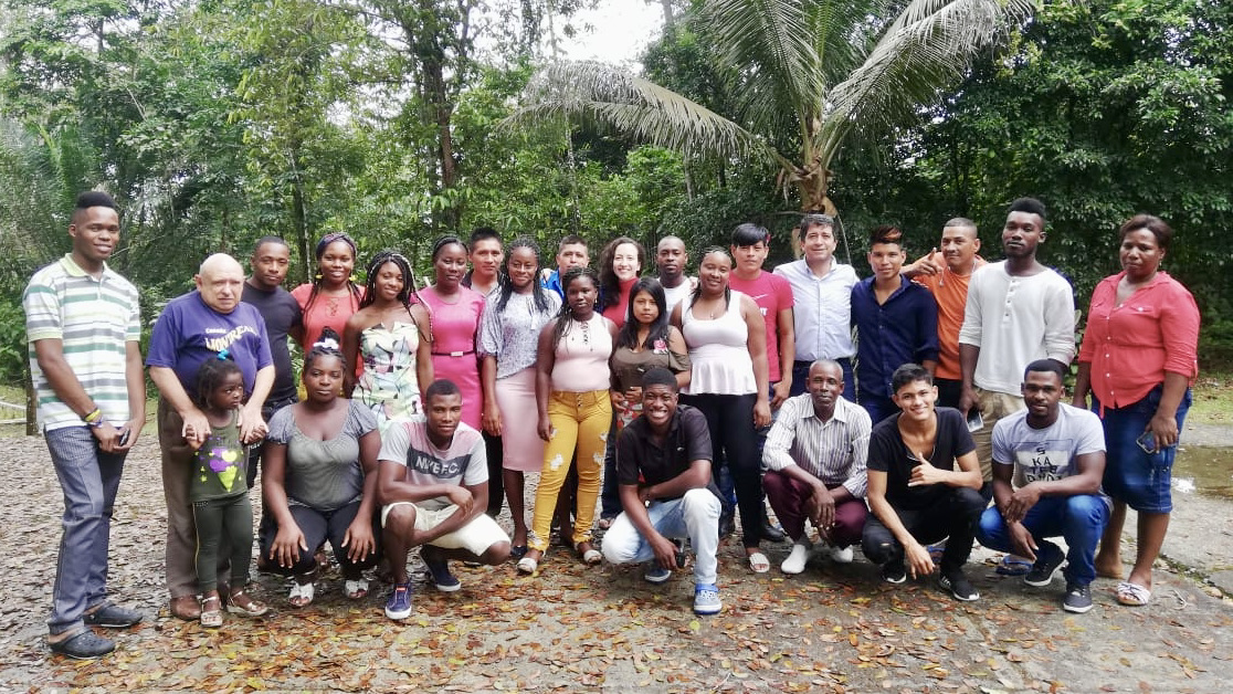 Landscape photo of student trainees from 2019 Jenzerá Work Collective cohort. Lush green background.