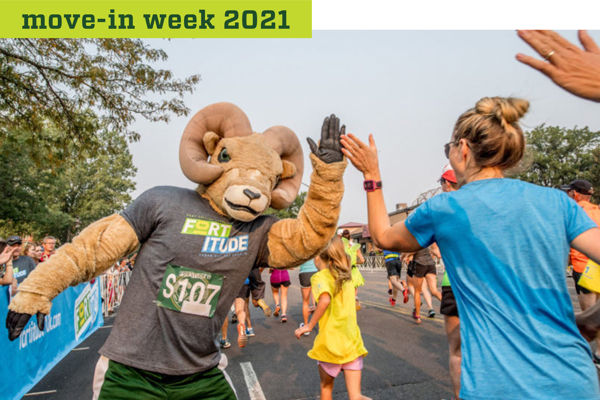 CAM the Ram giving a high five to runners