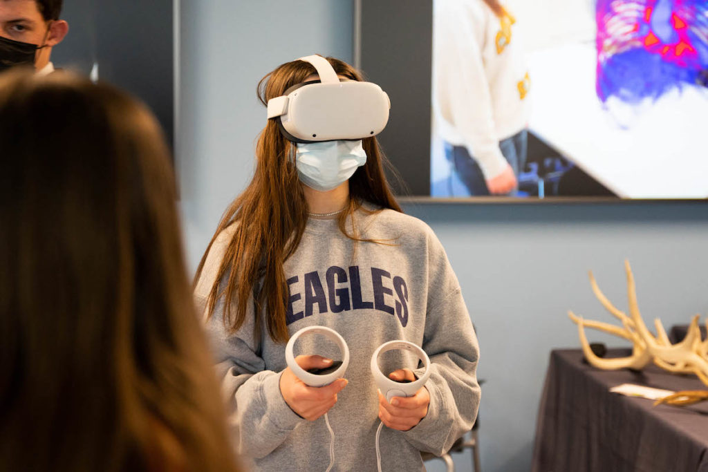 A girl wearing virtual reality goggles.