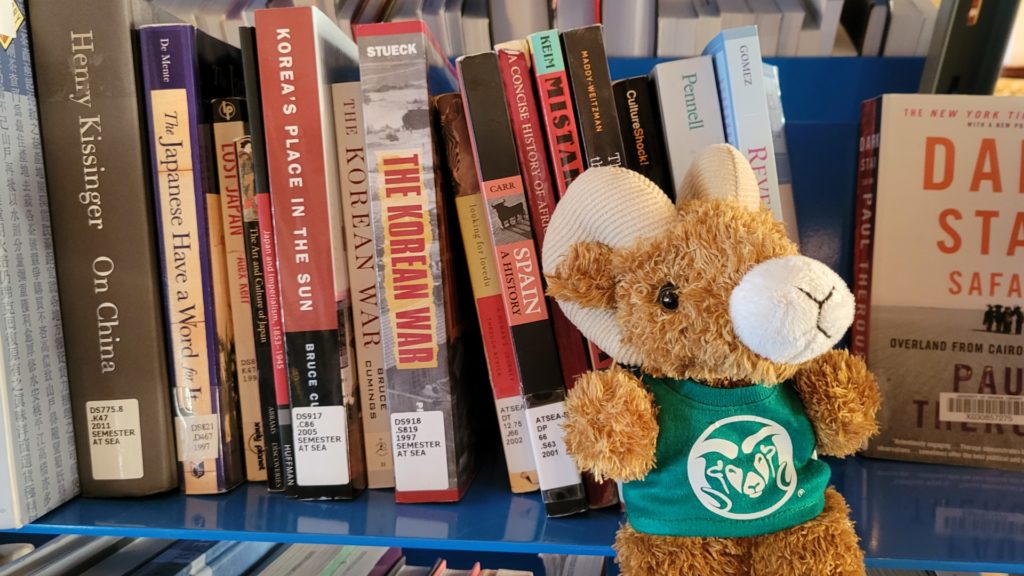 Semester at Sea library photo with a stuffed CAM the Ram