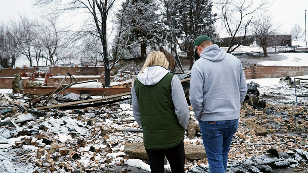Sophie Nelson and Matt Flick look over what remains of the home owned by the parents of her childhood friend, Prescott Delaware.