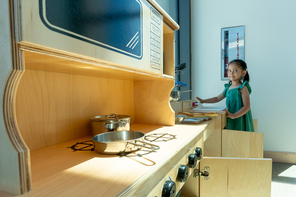 A little girl in the small kitchen at Terra