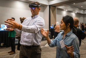 man using virtual reality headset with a demonstrator alongside him