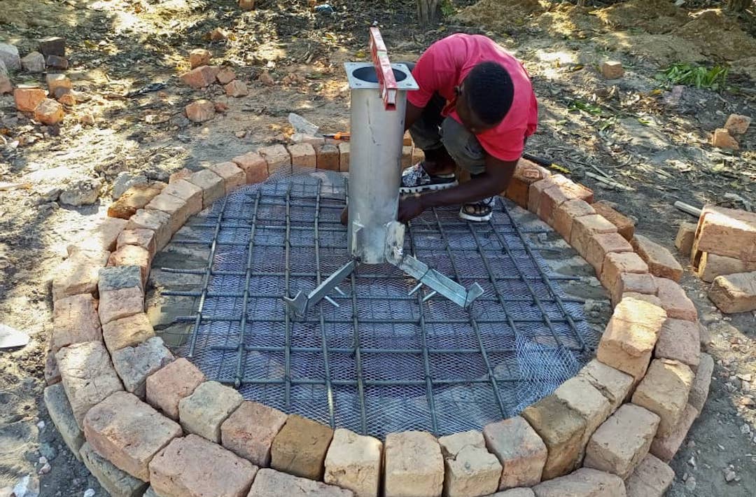Workers constructing water well