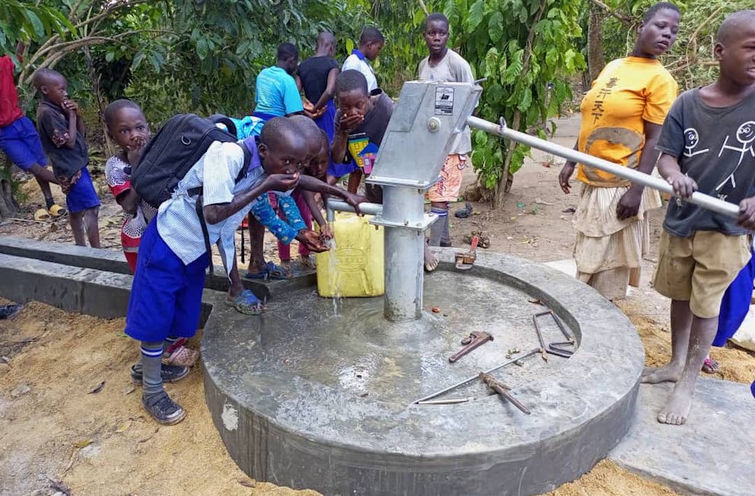Kids getting water from well