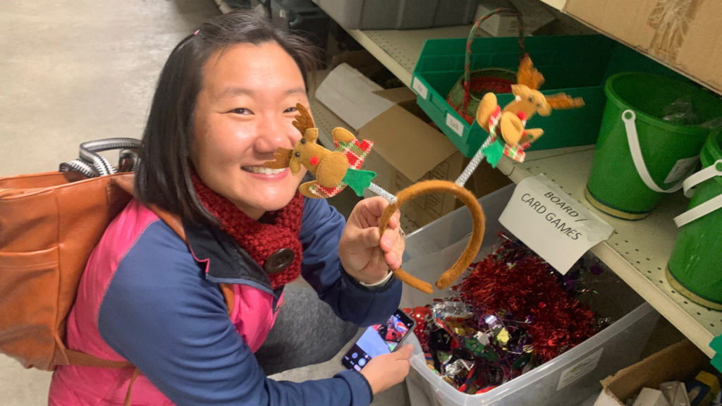 Anne Manning holding Holiday decorations at CSU Surplus