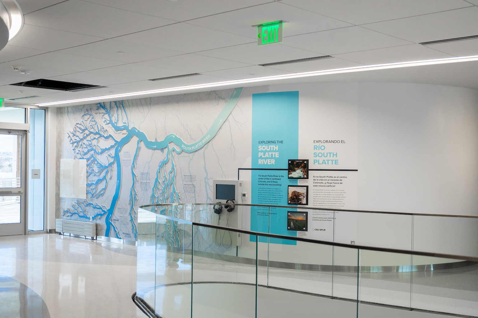 A wall-mounted exhibit shows an aerial view of a river system.