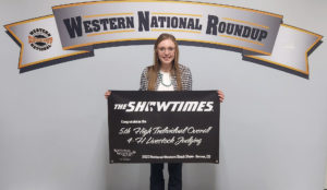 Tyla Thomas holds the banner she won during the Western National Roundup 4-H Livestock Judging Contest. 