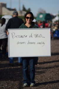 Person holding TRIO sign
