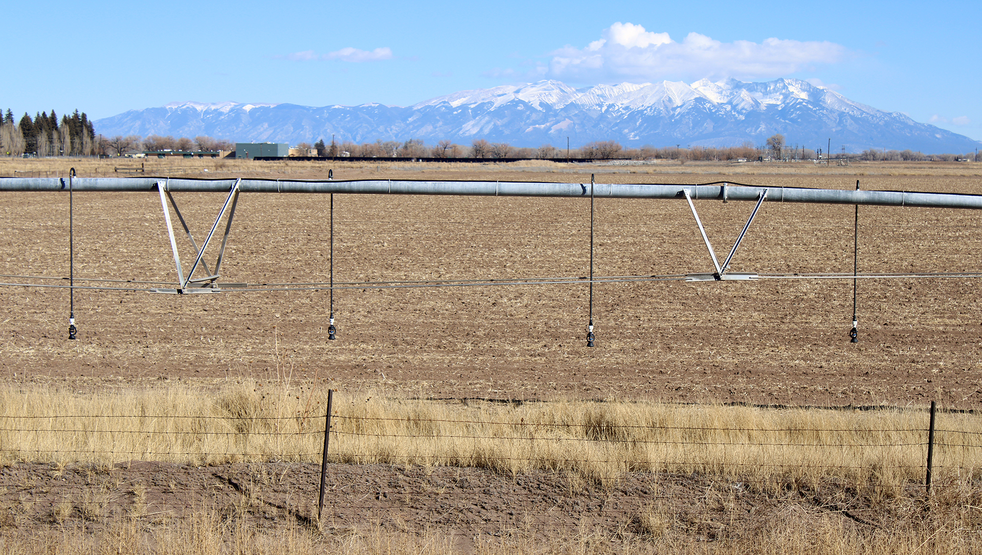 Irrigation equipment in a field with mountains in background