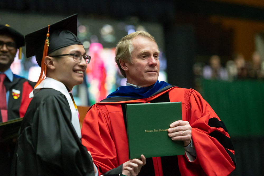 Walter Scott, Jr. College of Engineering Dean David McLean with a graduate.