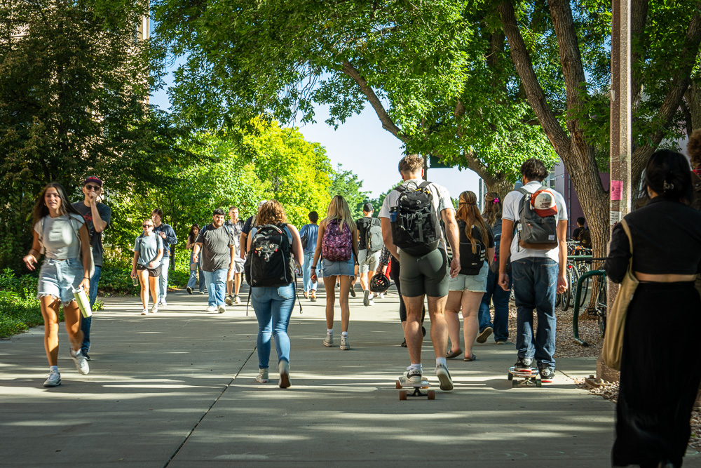 Students walk on a sidewalk.