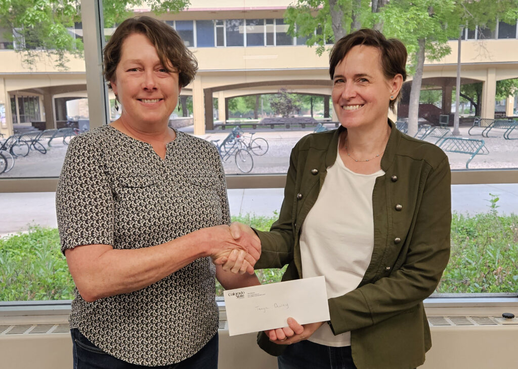 Tanya Dewey is presented with the Open Educator Award by Meg Brown-Sica, associate dean of research support and community engagement at the CSU Libraries.