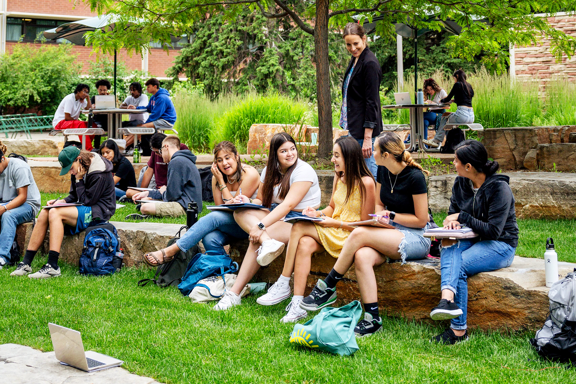 Colorado State University students and a faculty member learn outside during a summer class.