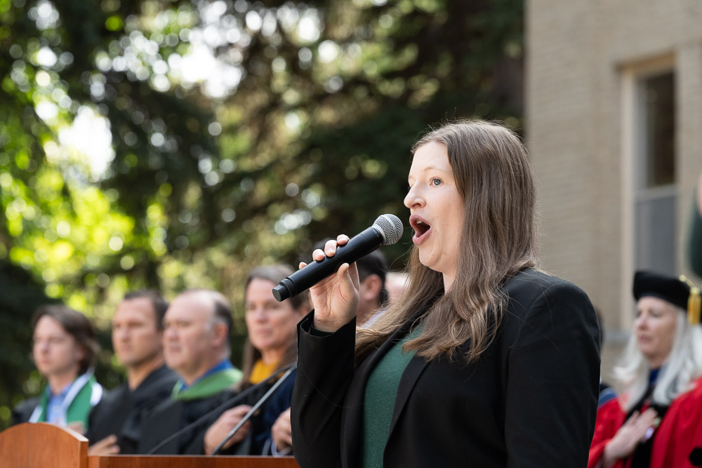 Kristy Shuck, Masters Student in Music, sings the National Anthem before the 2023 Fall Address and Presidential Investiture Ceremony on the steps of the Administration Building. October 4, 2023