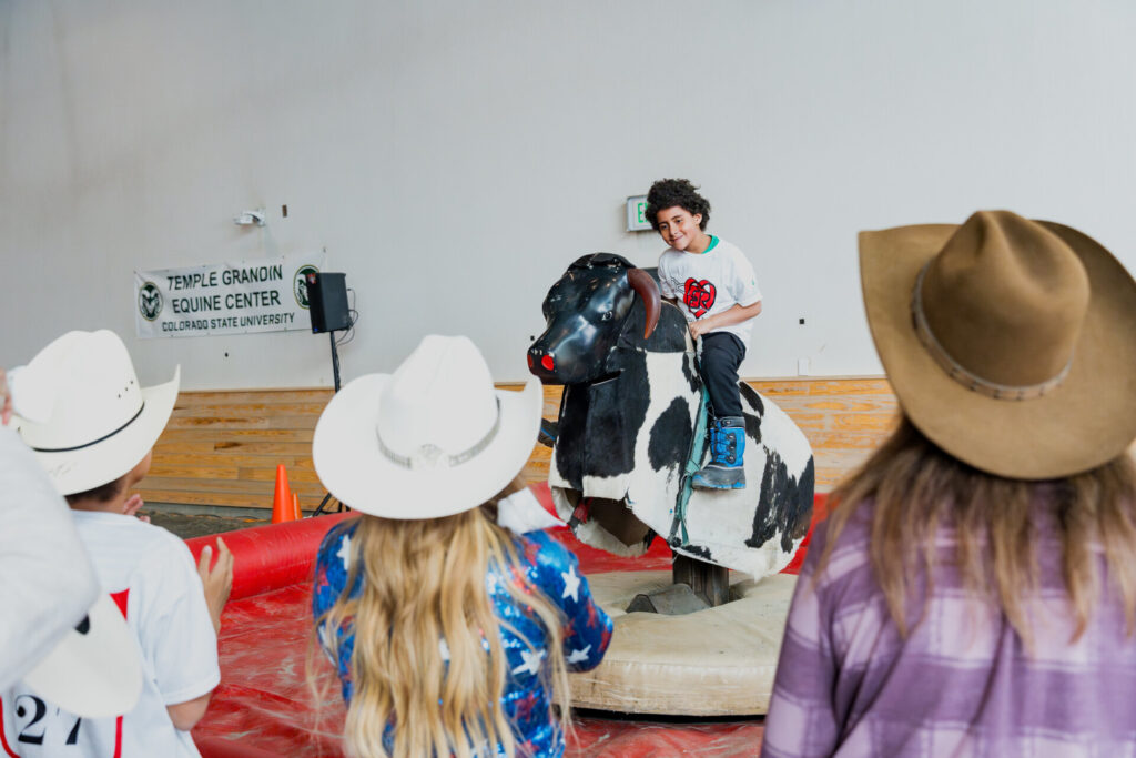 A child rides a mechanical bull at the Exceptional Rodeo